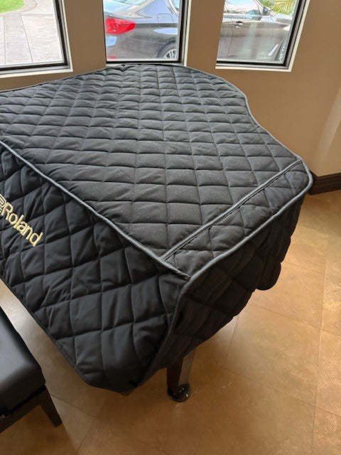Roland digital piano cover with embroidered logo. Black quilted mackintosh material.