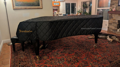 Bosendorfer piano cover in black quilted nylon in living room.