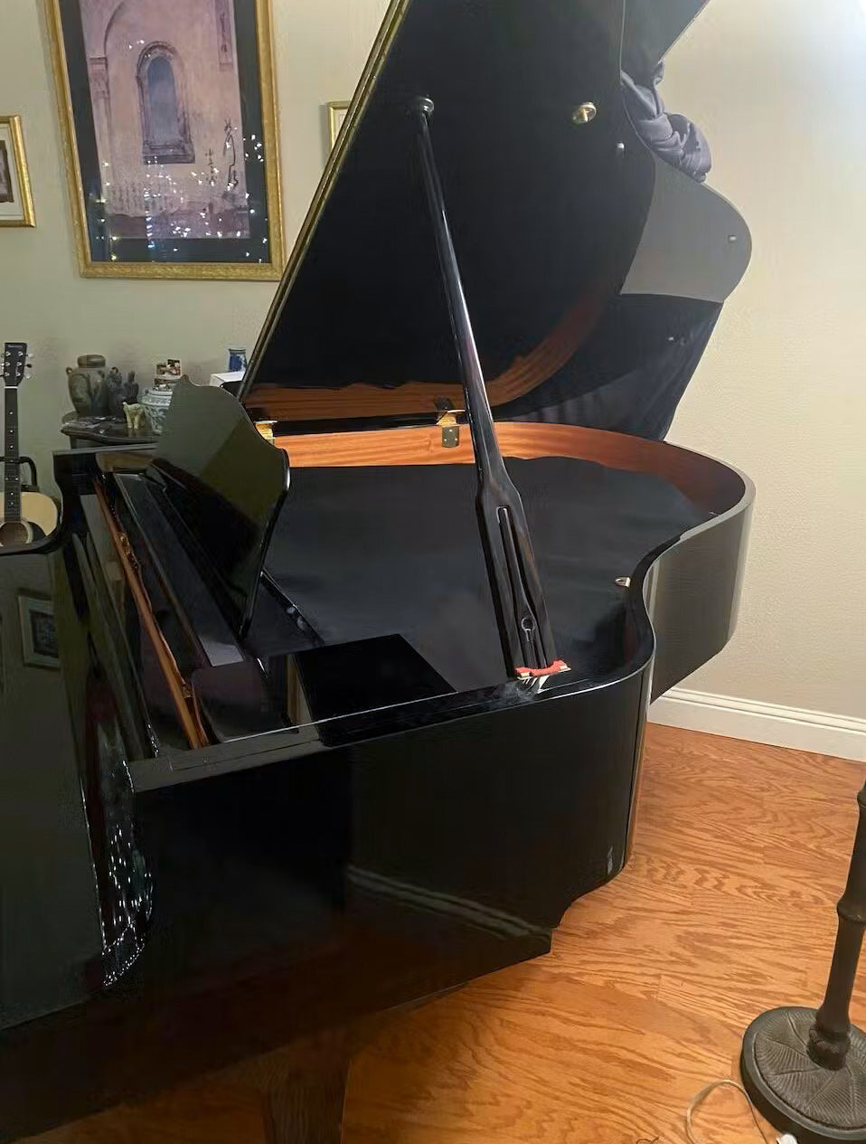 Black felt piano string cover installed on a Yamaha C1 grand piano