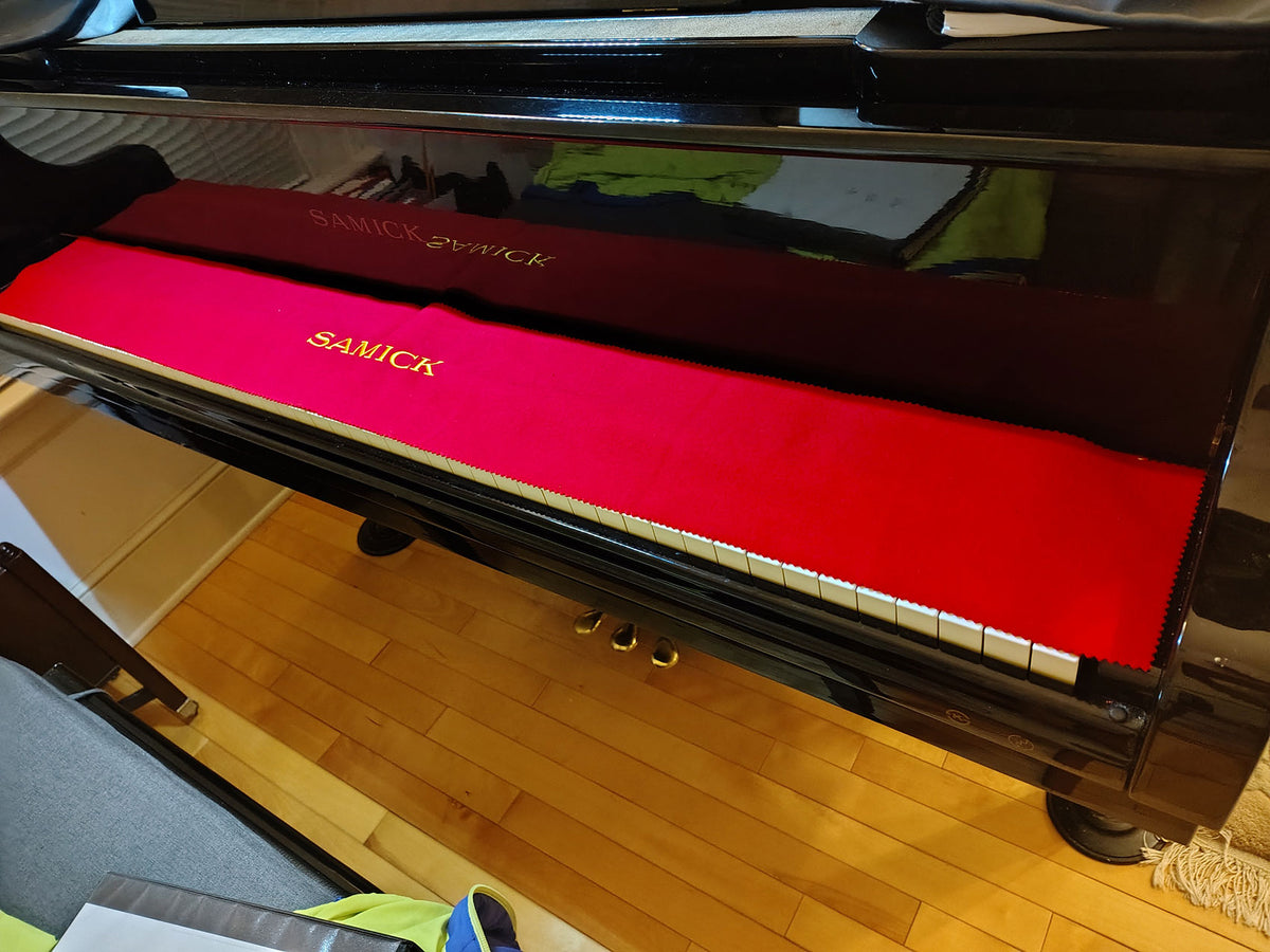 samick red felt piano key cover on samick grand piano