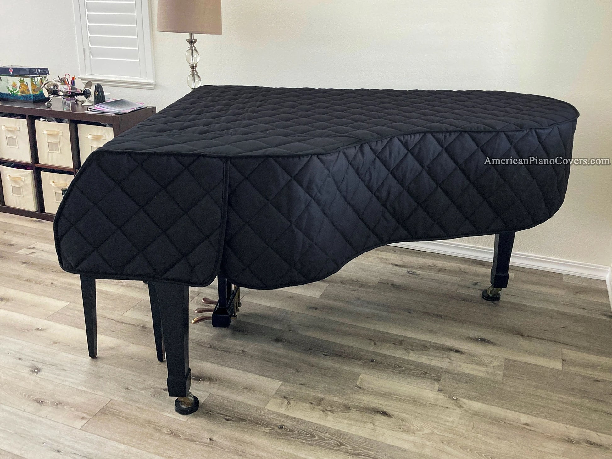 Heavy-duty Yamaha piano cover—black quilted fabric for extra protection.